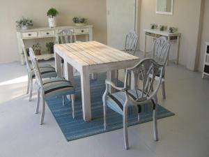 a dining room table with four chairs around it at Ladismith Manor in Ladismith
