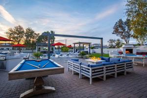a patio with couches and a pool table and a fireplace at The Epic Resort an Acre of Fun for Everyone in Chandler +114 photos