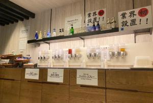 a counter with a bunch of glasses on it at Hotel YAN-NEKO in Hirakata
