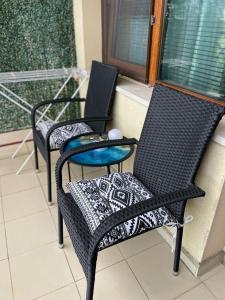 two chairs and a table on a balcony at M&V House in Balchik