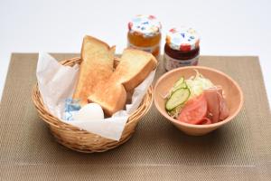 a basket of bread and a bowl of salad and a sandwich at Hotel YAN-NEKO in Hirakata +5 photos