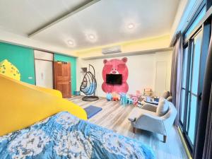 a bedroom with a large bear in the corner of the room at 山田心溜滑梯民宿 in Chiang-hsi-shan-lin