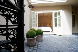 a bedroom with a bed and a door with bushes at B&B Maryline in Antwerp