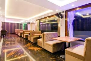 a row of chairs and tables in a train car at Super Townhouse AIIMS Kolkata Formerly Tanish Inn in Kalyani