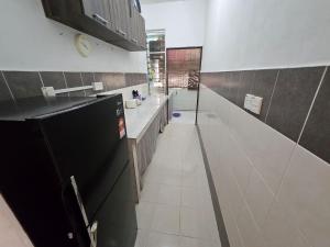 a large kitchen with a sink and a counter at Hadi's Homestay in Sandakan
