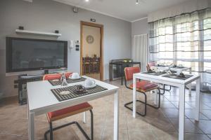 a living room with two tables and a flat screen tv at Villa Malù in Citta' Sant'Angelo