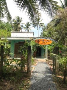 a building with an orange sign in front of it at Bến Tre Homestay in Ben Tre