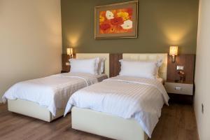 Postel nebo postele na pokoji v ubytování KEIT Hotel