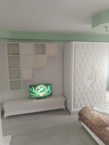 a bedroom with a bed and a tv on a bench at Children room Hunedoara in Hunedoara +5 photos