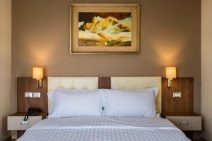 Postel nebo postele na pokoji v ubytování KEIT Hotel