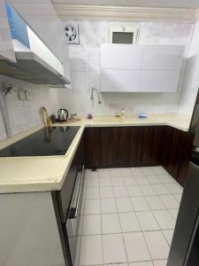 a kitchen with white cabinets and a sink at شقة غرفة نوم ومجلس ومطبخ وحمام in Jeddah