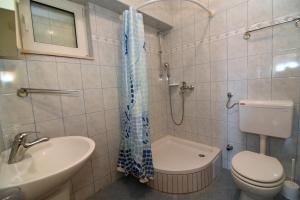 a bathroom with a toilet and a sink and a shower at Apartments Ćorić in Baška Voda +46 photos