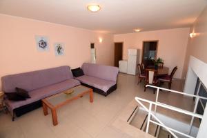a living room with a couch and a table at Apartments Ćorić in Baška Voda
