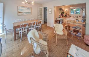 a kitchen and dining room with a table and chairs at Amazing Home In Névez With Wifi in Névez