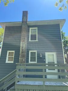a house with a chimney on the side of it at Spacious 1 Bedroom Duplex in Lansing
