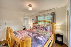 a bedroom with a wooden bed and a window at Nature Sounds Retreat in Boone