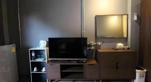 a television on a wooden dresser with a mirror at One Beat Vintage&Bistro in Ban Puk (1) +91 photos