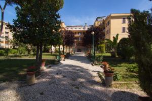 a courtyard with potted plants in front of a building at Ostello Villa Monte Mario in Rome