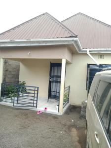 a house with a porch and a door at World Heart Africa Experience in Arusha