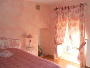 a bedroom with a bed and a window at Les sources in Poilley