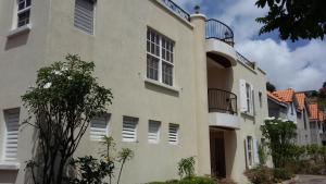 a building with balconies on the side of it at 10 Springcourt Barbados in Bridgetown
