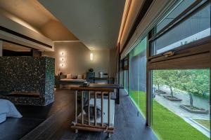 a room with a large window in a house at Xi'an Zhiyin Courtyard Designer Hotel in Xi'an