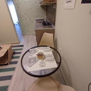 a table with a plate of food on top of it at Central Modern Living Apartment 1 in Eleftheroúpolis