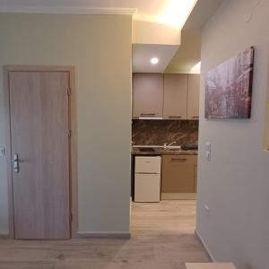 an empty room with a kitchen and a door at Central Modern Living Apartment 1 in Eleftheroúpolis