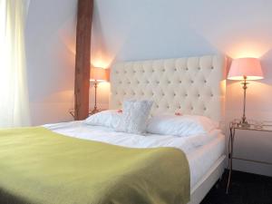 a bedroom with a large white bed and two lamps at Rezydencja Solei Strzeszyn in Poznań +36 photos