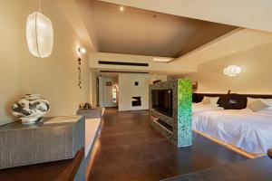 a bedroom with a bed and a tv in it at Xi'an Zhiyin Courtyard Designer Hotel in Xi'an