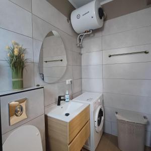 a bathroom with a sink and a washing machine at Central Modern Living Apartment 1 in Eleftheroúpolis +23 photos