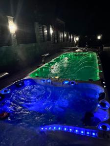a large blue tub with green liquid in it at Луксозна вила - Стрелча, джакузи с минерална вода in Strelcha