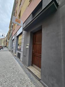 a building with a wooden door on the side of a street at Apatments Prague by Yuliia in Prague