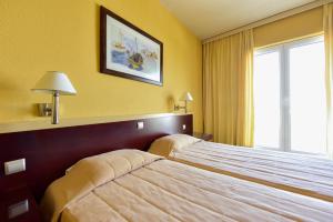 Ein Bett oder Betten in einem Zimmer der Unterkunft Arion
