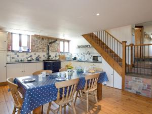 a kitchen and dining room with a table and chairs at Swallows Cottage in Bideford