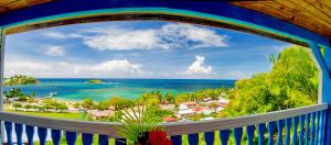 a view of the ocean from a balcony at Hotel Le Manguier in Quartier Morne Pavillon