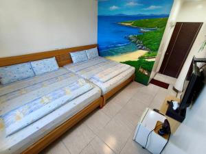 Postel nebo postele na pokoji v ubytování Yujing B&B