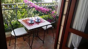 a table with two cups and two chairs on a balcony at Villa Sandra Hvar in Hvar