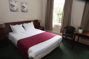 Postel nebo postele na pokoji v ubytování Hotel Le Monte Cristo