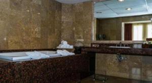 特古西加尔巴Hotel Honduras Maya的带浴缸、水槽和镜子的浴室