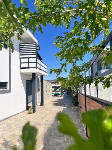 a building with a balcony on the side of a street at Two Bedroom Villa with Private Pool & Garden by Olivujoj in Anavyssos
