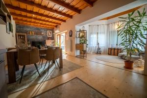 a living room with a wooden ceiling and a table at FoxForest Vendégház in Zalakaros