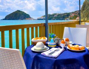 a table with a blue table cloth with food on it at Hotel Regina del Mare in Ischia