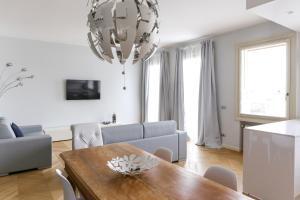 a living room with a table and a couch at Riverside Apartment in Treviso