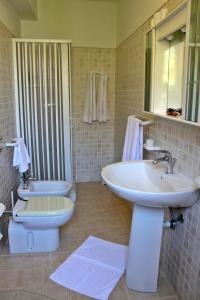 a bathroom with a sink and a toilet at Raggio di Sole Bed & Breakfast in Macari
