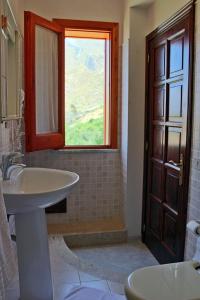 a bathroom with a sink and a window at Raggio di Sole Bed & Breakfast in Macari