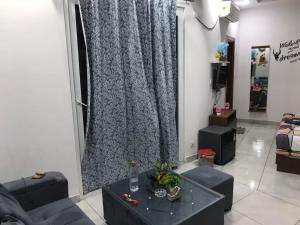 a living room with a couch and a large window at Crystal homes in Noida