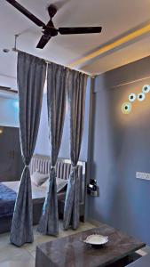 a bedroom with a bed and a ceiling fan at Crystal homes in Noida