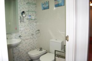a small bathroom with a toilet and a sink at Marineu Las Arenas in Alcossebre +36 photos