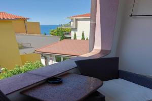 a balcony with a bench and a view of the ocean at Guest House Villa Daniel - Two Bedroom Apartment with Balcony in Omiš